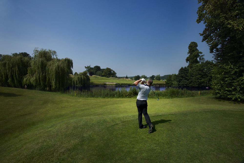 Driving over the water on the King's Course,The Warwickshire Golf Club, England