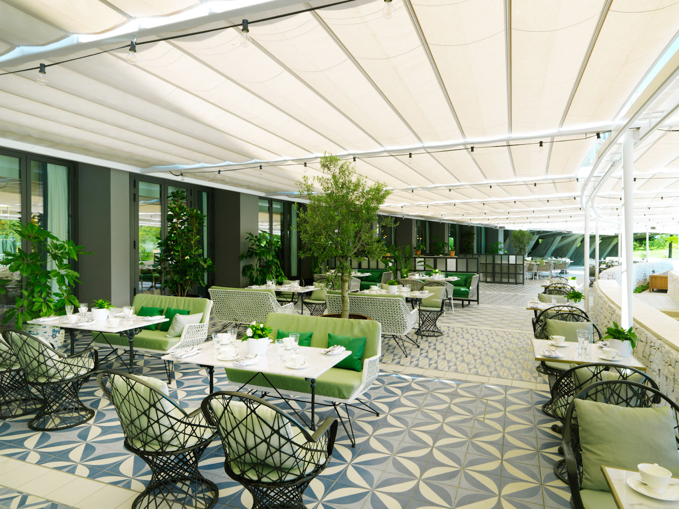 Shaded outdoor dining at Hotel Camiral PGA Catalunya Golf Resort, Costa Brava, Spain