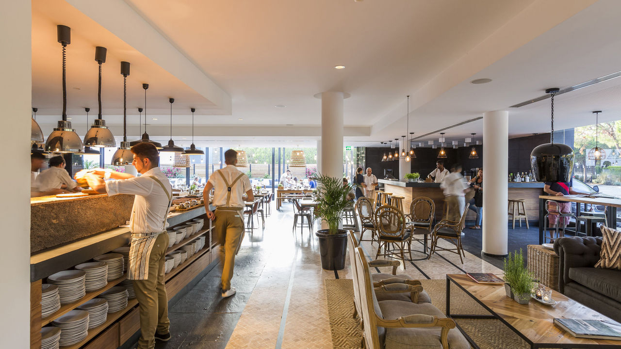 Waiters serving in the restaurant at Praia Verde Boutique Hotel Castro Marim, Algarve, Portugal