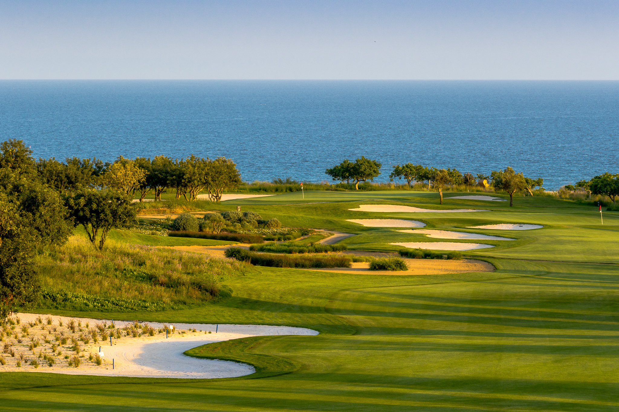 Hitting down the fairway to the Atlantic Ocean at Quinta da Ria golf course, Tavira, Algarve, Portugal