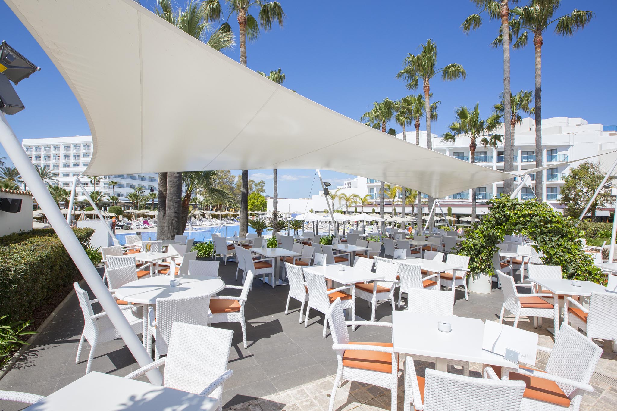 Sit in the sun and enjoy a drink at Hipotels Cala Millor Park, Palma, Mallorca