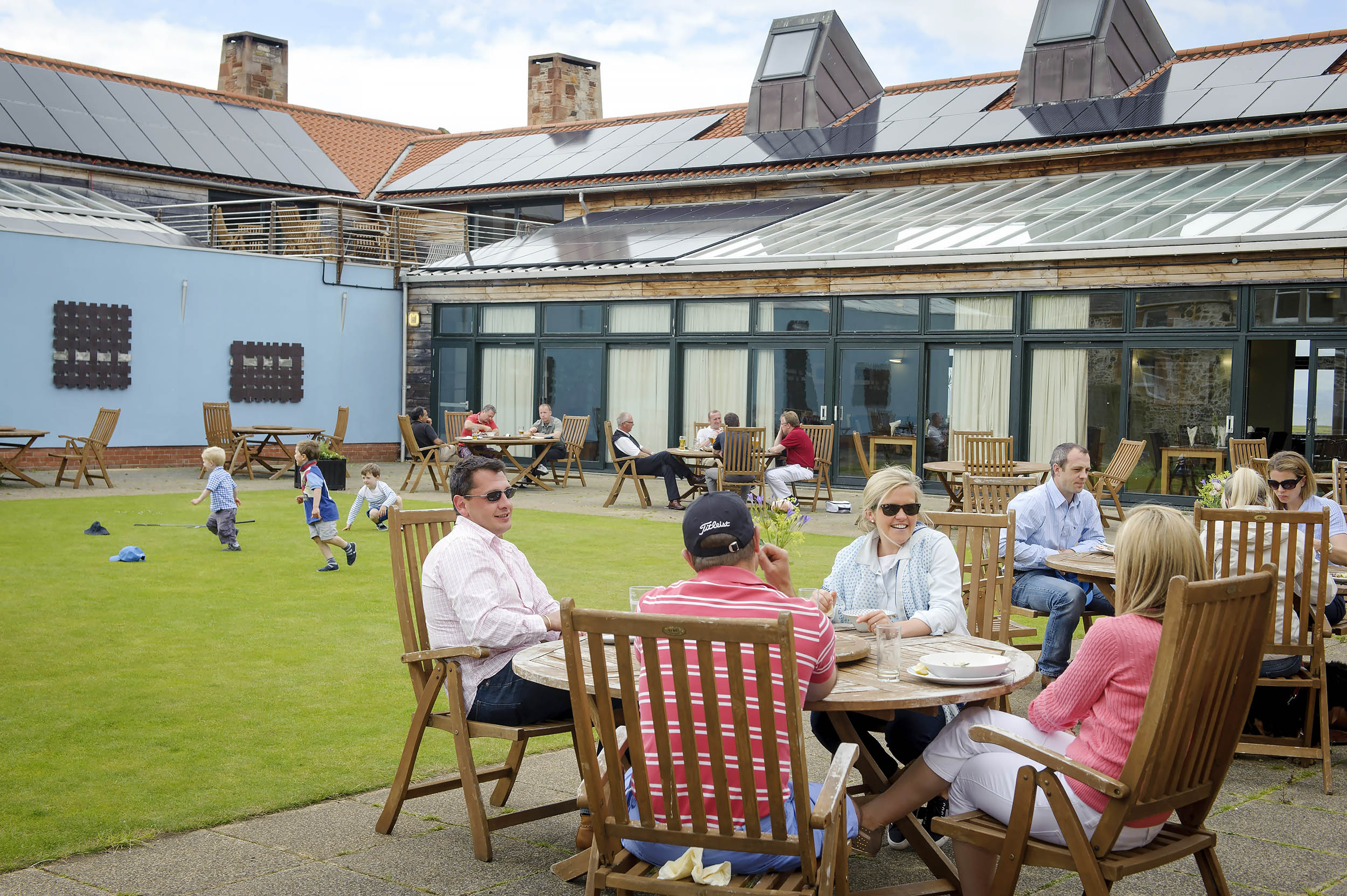 Children and adults on the terrace at Craigielaw Golf Club, East Lothian, Scotland
