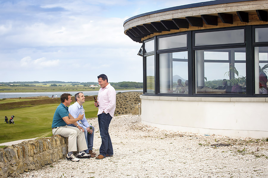 Three golfers enjoying a drink after a round at Craigelaw Golf Club, Scotland