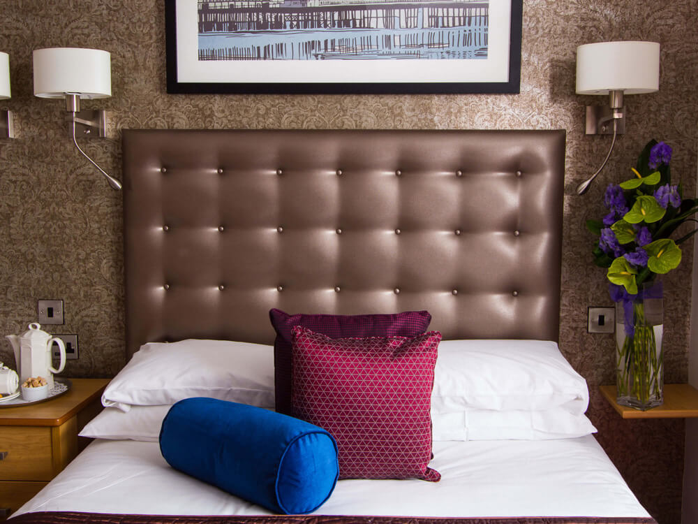 A comfortable bedroom at The Cooden Beach Hotel, Bexhill-on-Sea, England