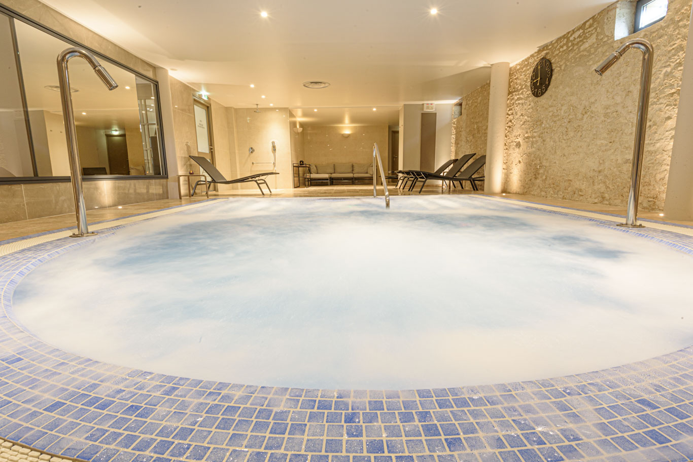 Relax by the spa pool at Chateau des Vigiers Golf Resort, Dordogne, France